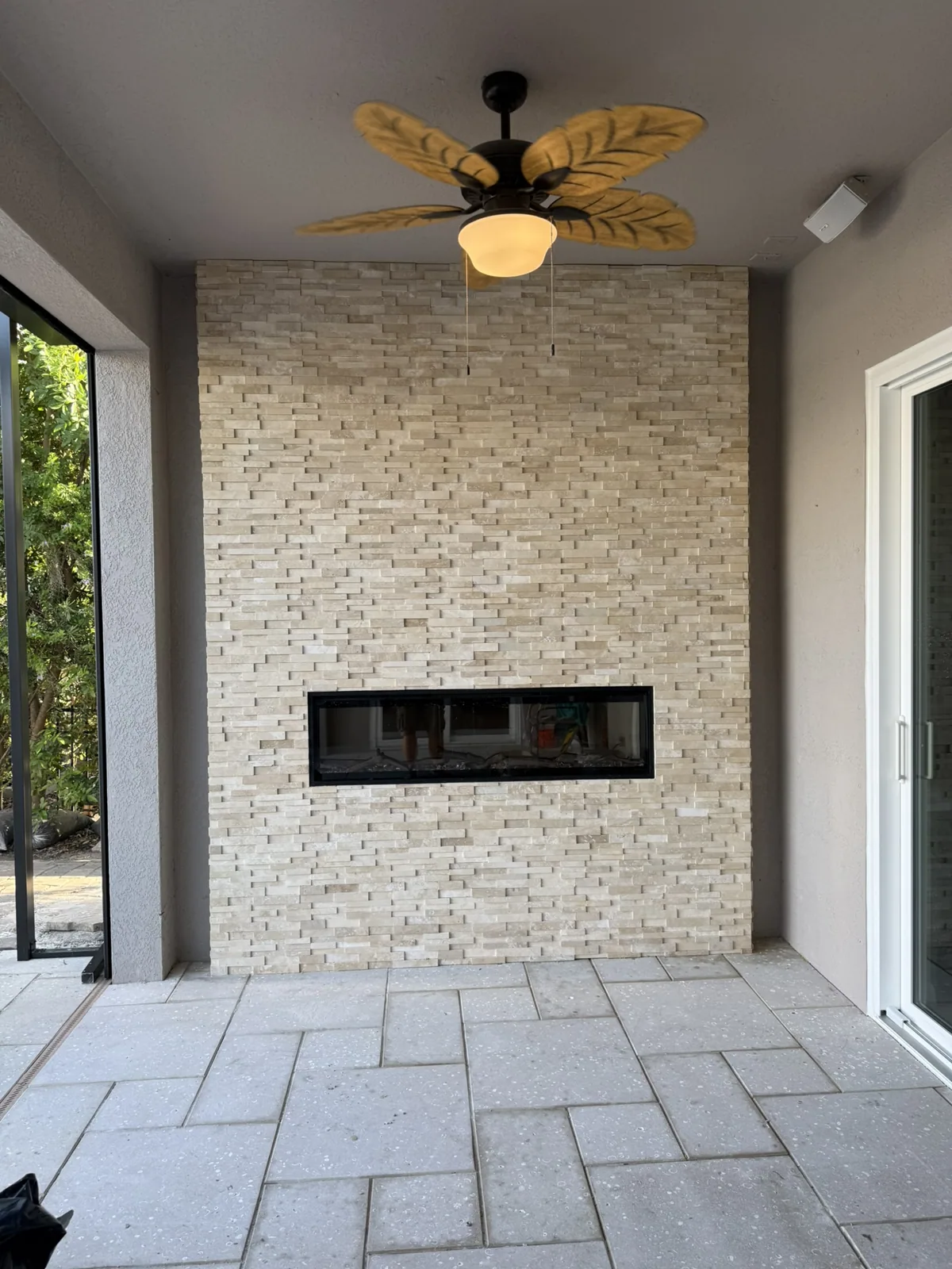 Stone fireplace wall with tile and stone installation in Tampa Bay